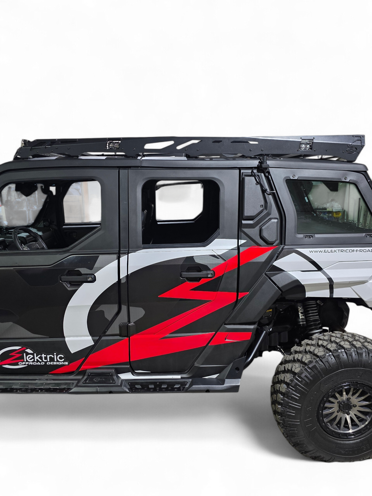 Rear quarter view of the Xpedition ADV5 with EOD graphics and the roof rack above