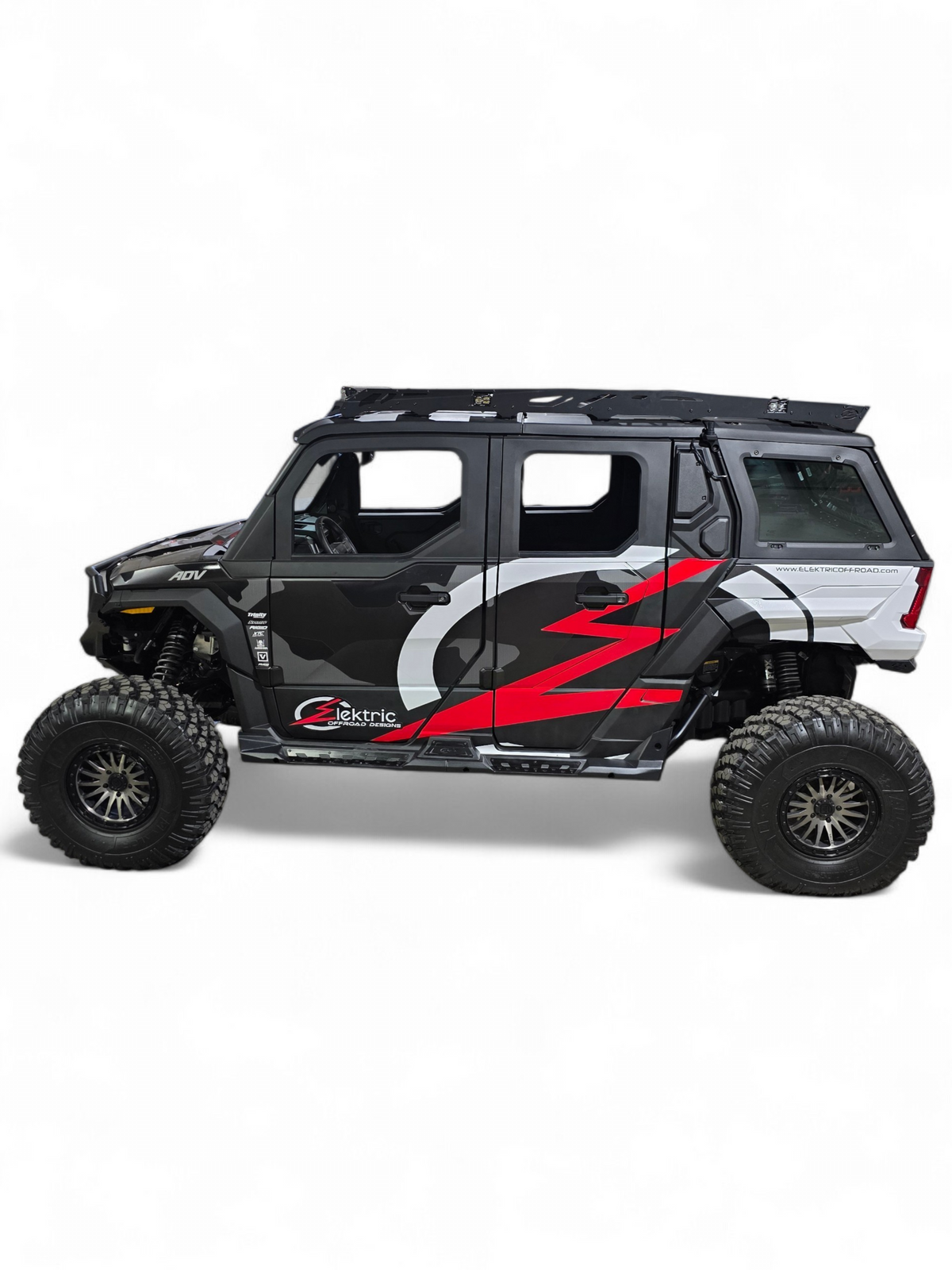 Side view of a black Polaris Xpedition ADV5 with red and gray EOD graphics and the roof rack overhead