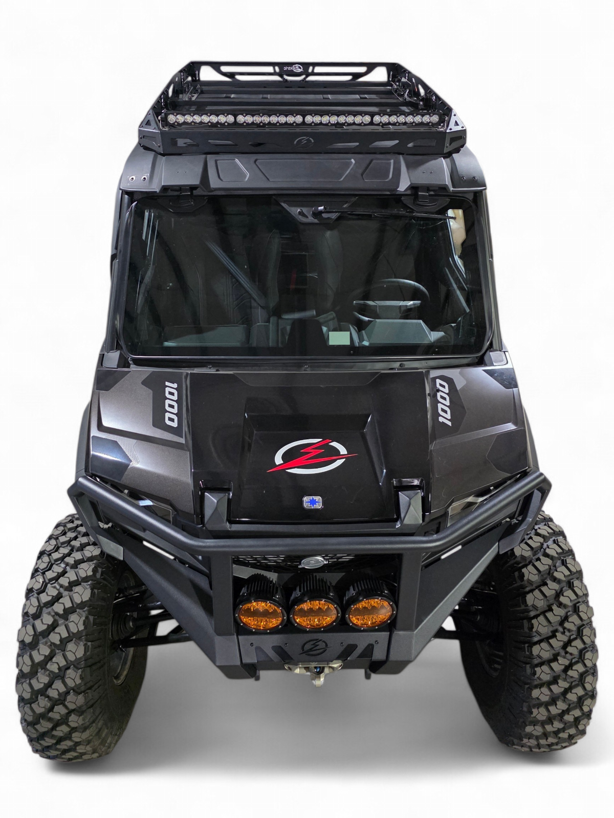 Front view of a black Polaris Xpedition with EOD front bumper, amber lights, and roof rack