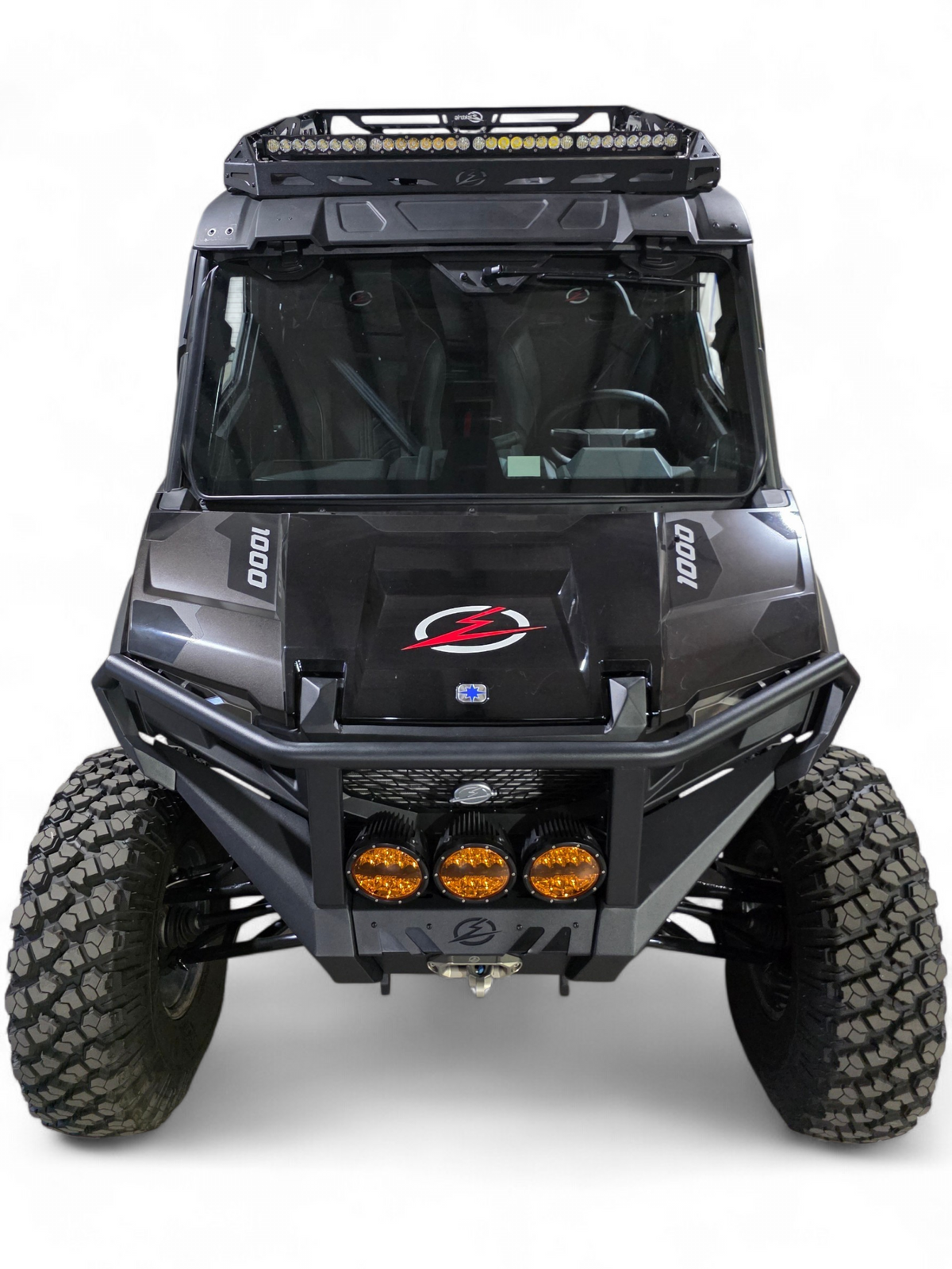 Head-on view of the black Xpedition with three amber bumper lights and roof rack above