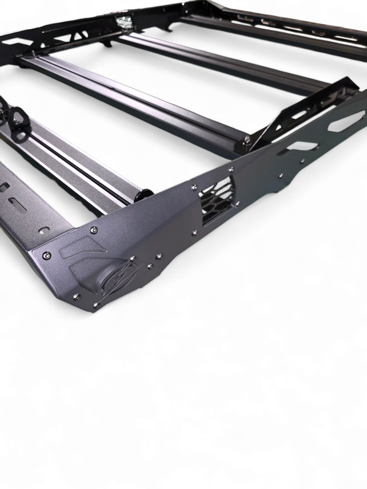 Close-up of a roof rack corner and side rail with cutouts and mounting points