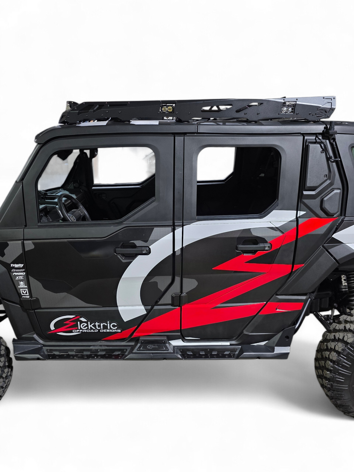 Side door and roof edge of a Polaris Xpedition with red and gray EOD graphics under the roof rack