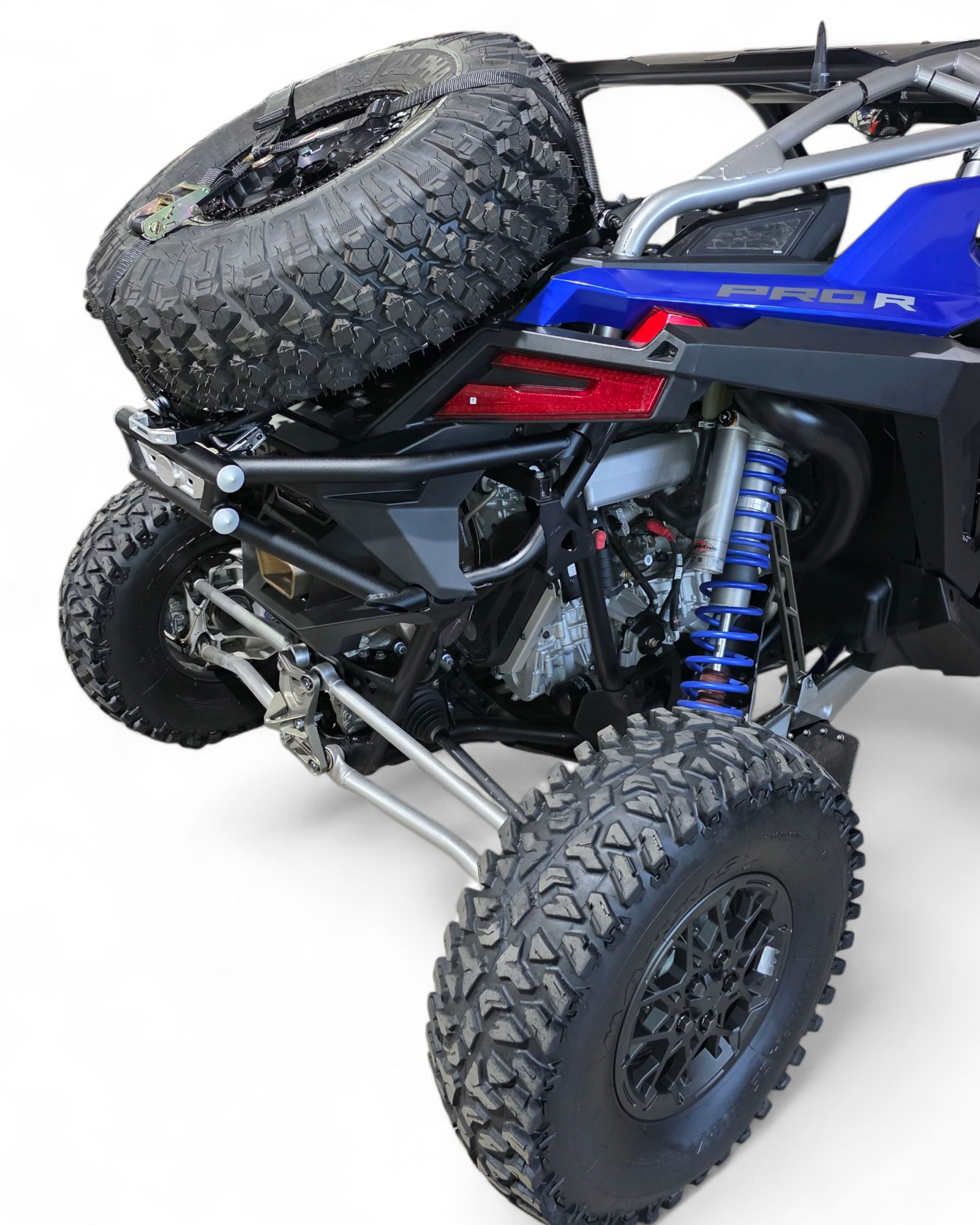 Amp Rear Bumper and Tire Rack Combo installed on Polaris RZR Pro R showing integrated rear system in hammer black