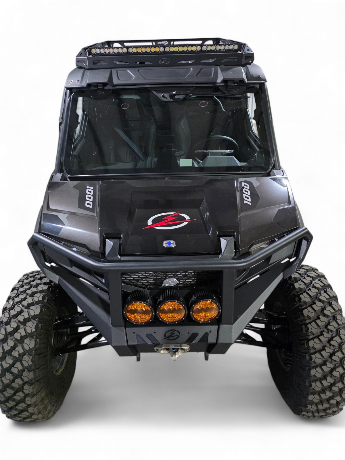 Angled front view of the black Xpedition with EOD bumper lights and roof rack overhead